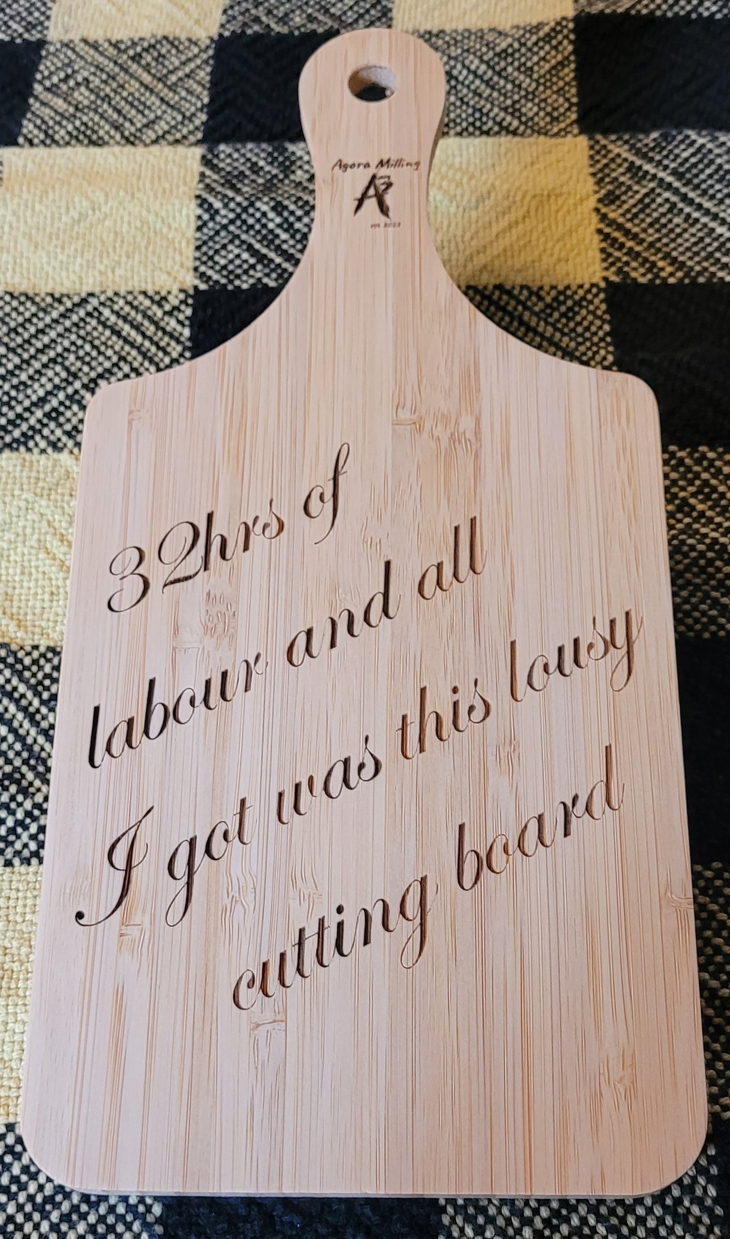 Wooden cutting board with engraved text