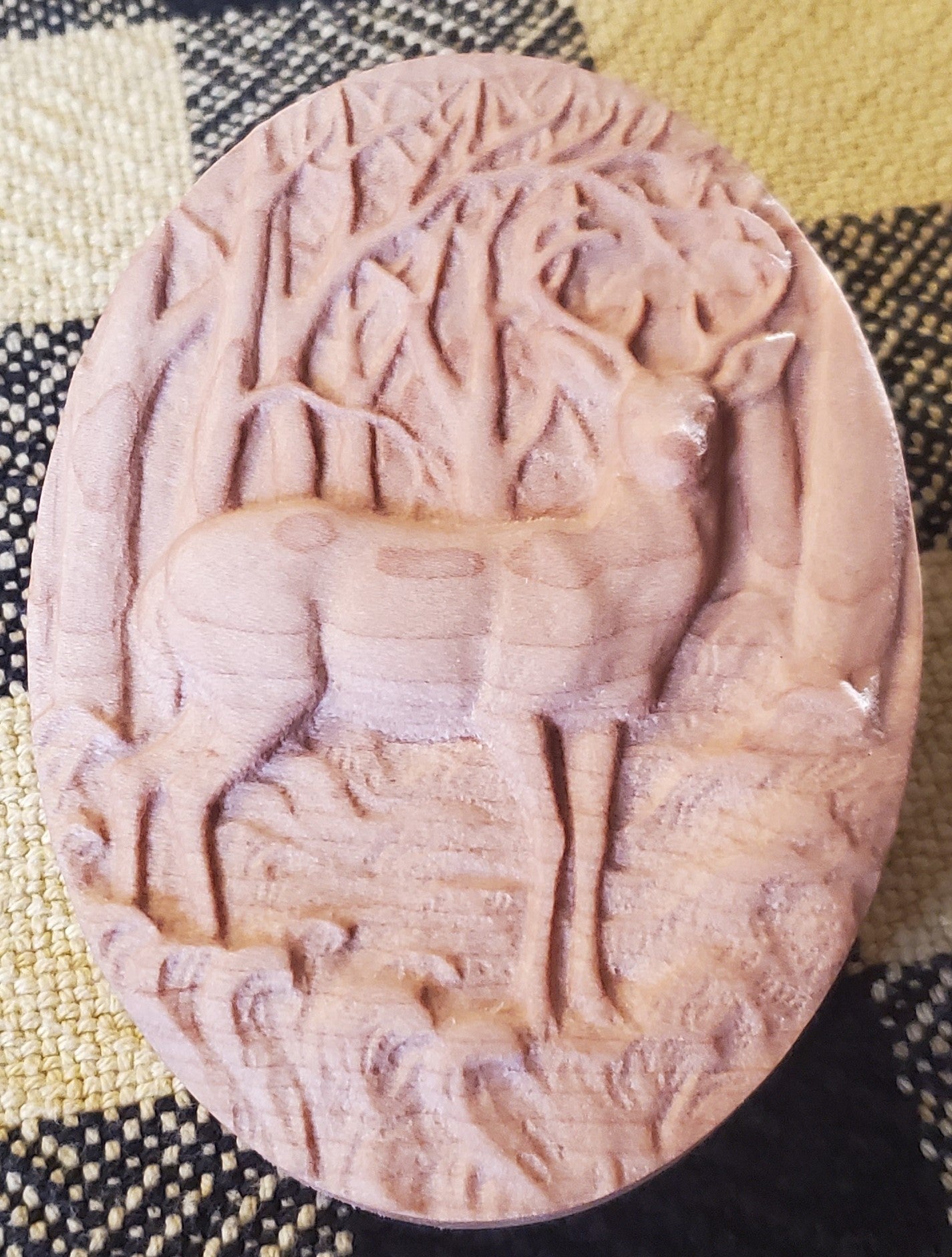 Carved maple with a deer and tree design