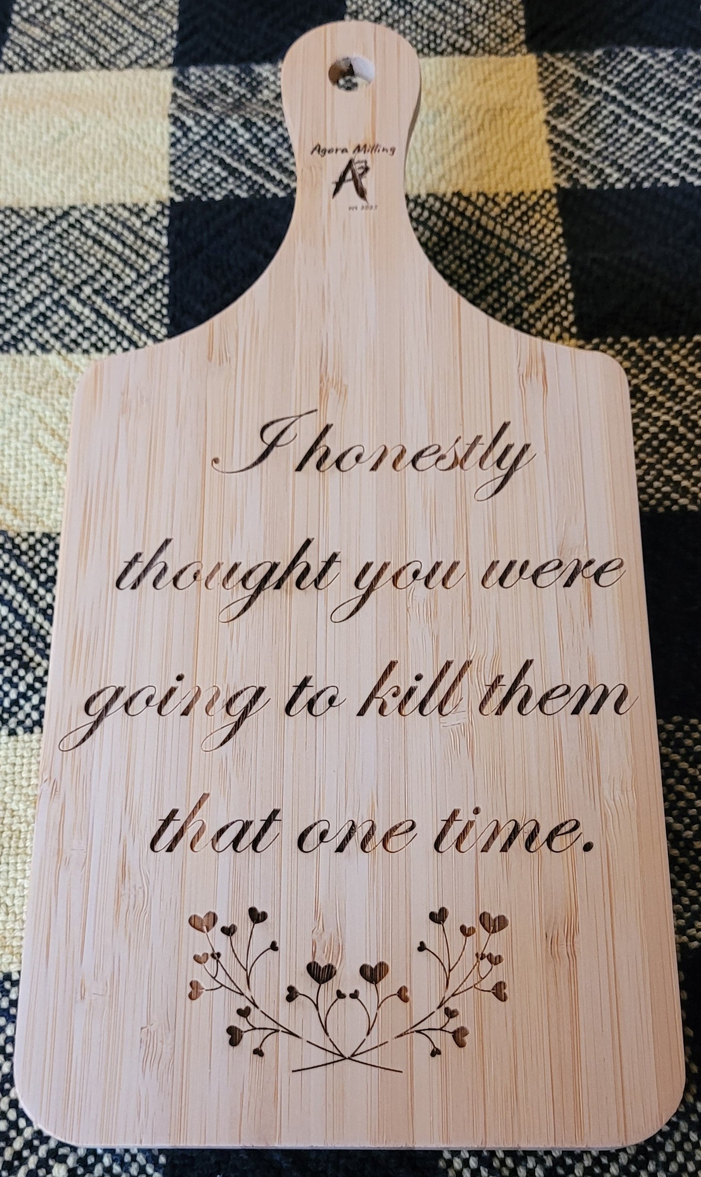 Wooden cutting board with engraved text and design