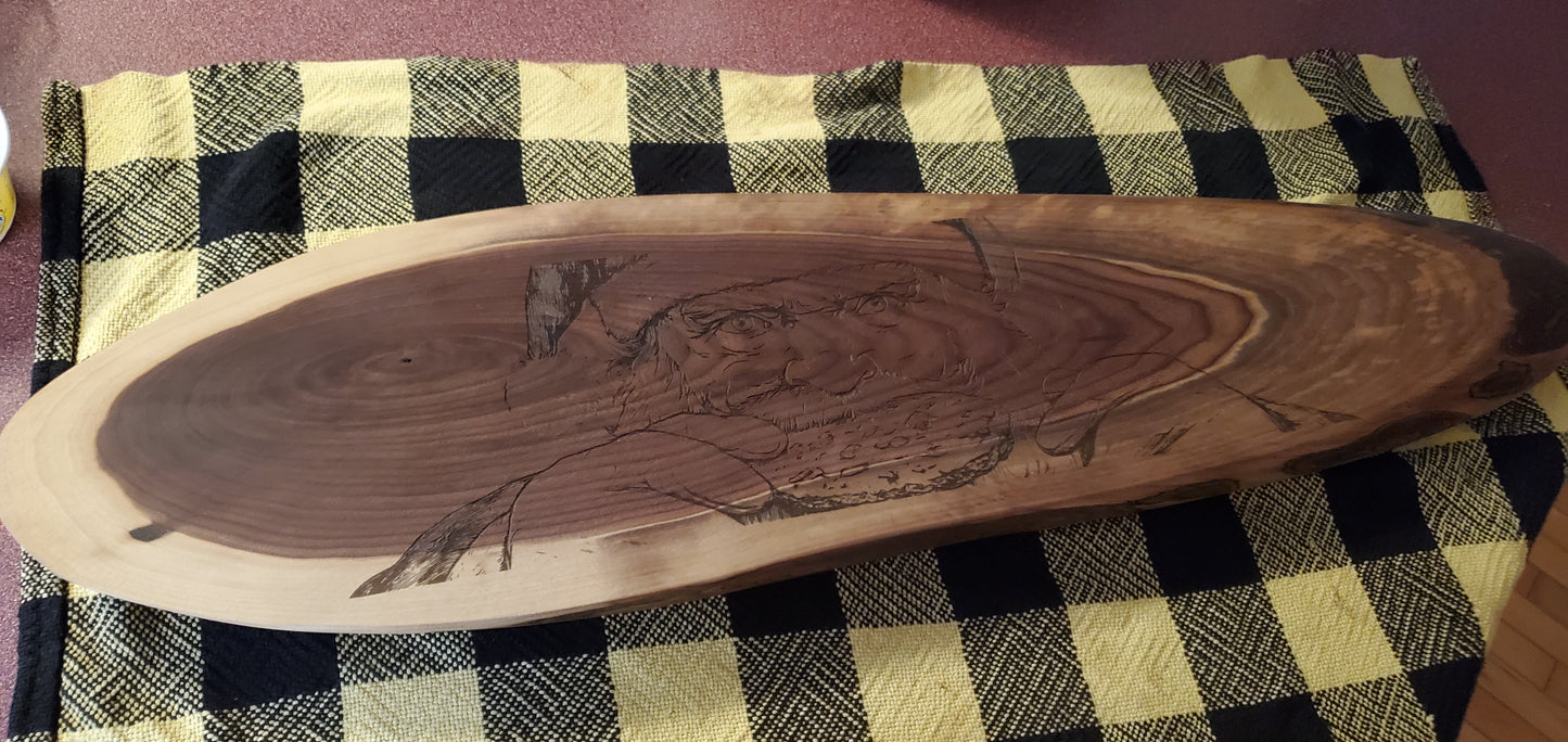 Wooden cutting board with carvings on a checkered tablecloth