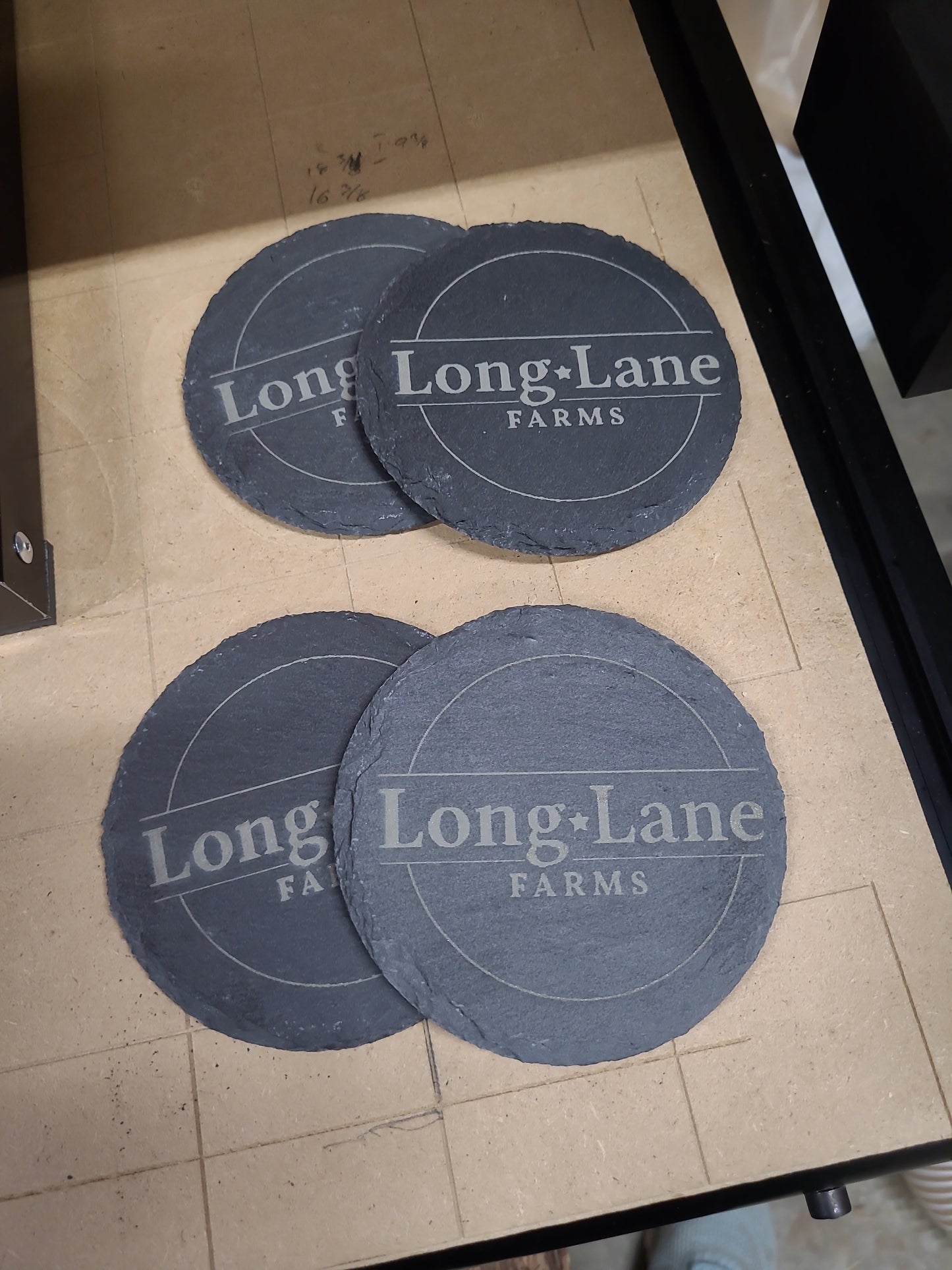 Three round blue coasters with 'Long Lane Farms' branding
