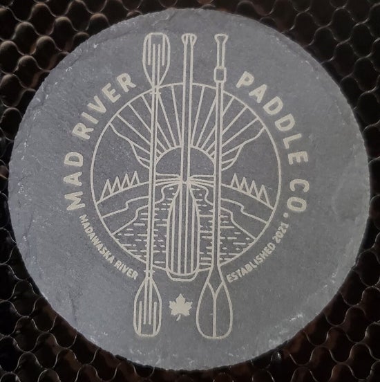 Round slate coaster with engraved design and text