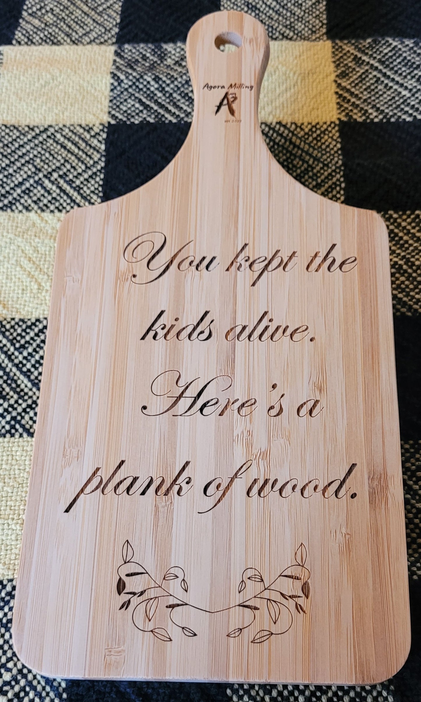 Wooden cutting board with engraved text and design