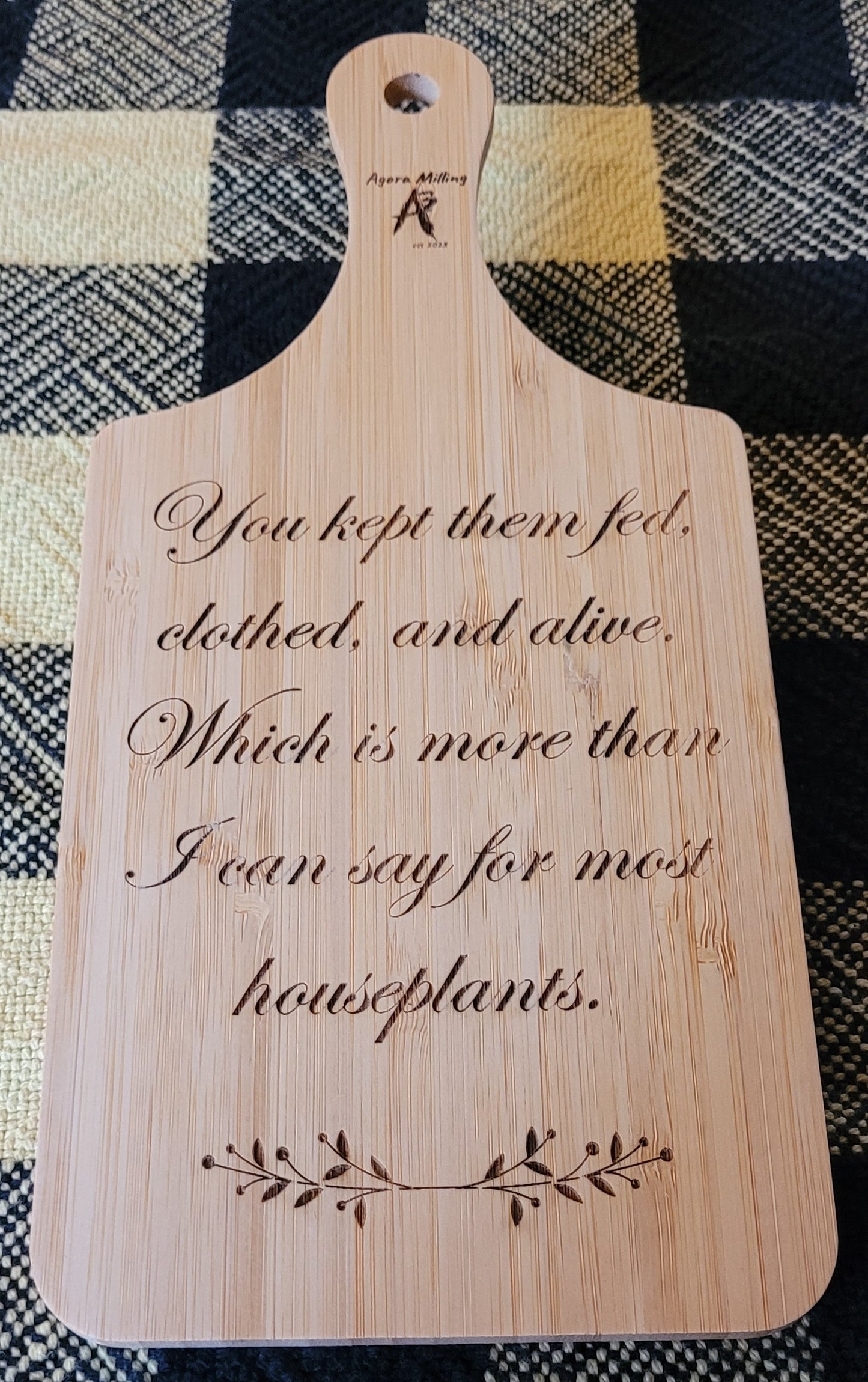 Wooden cutting board with engraved text