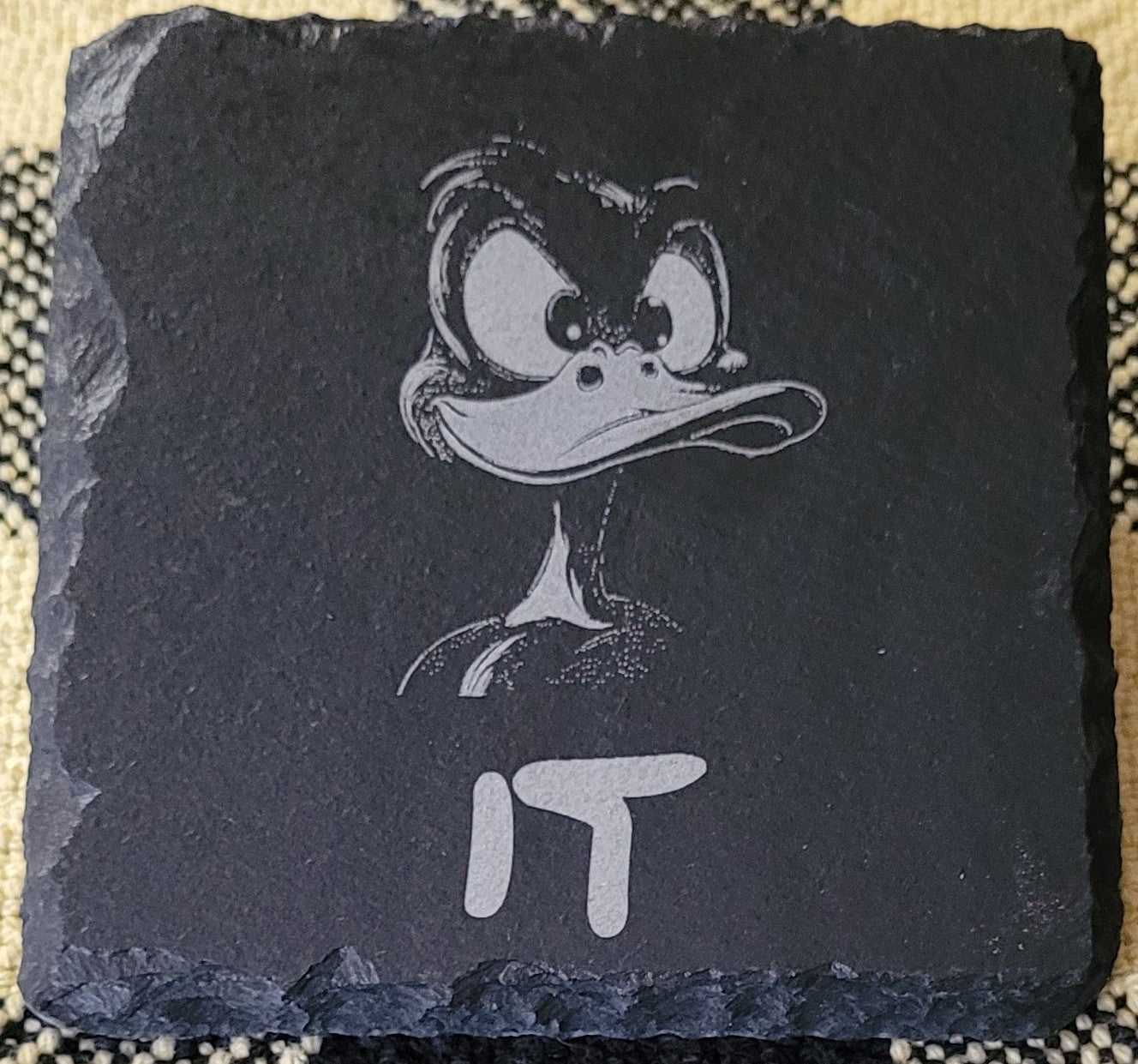 Slate coaster with engraved cartoon character and 'IT' text
