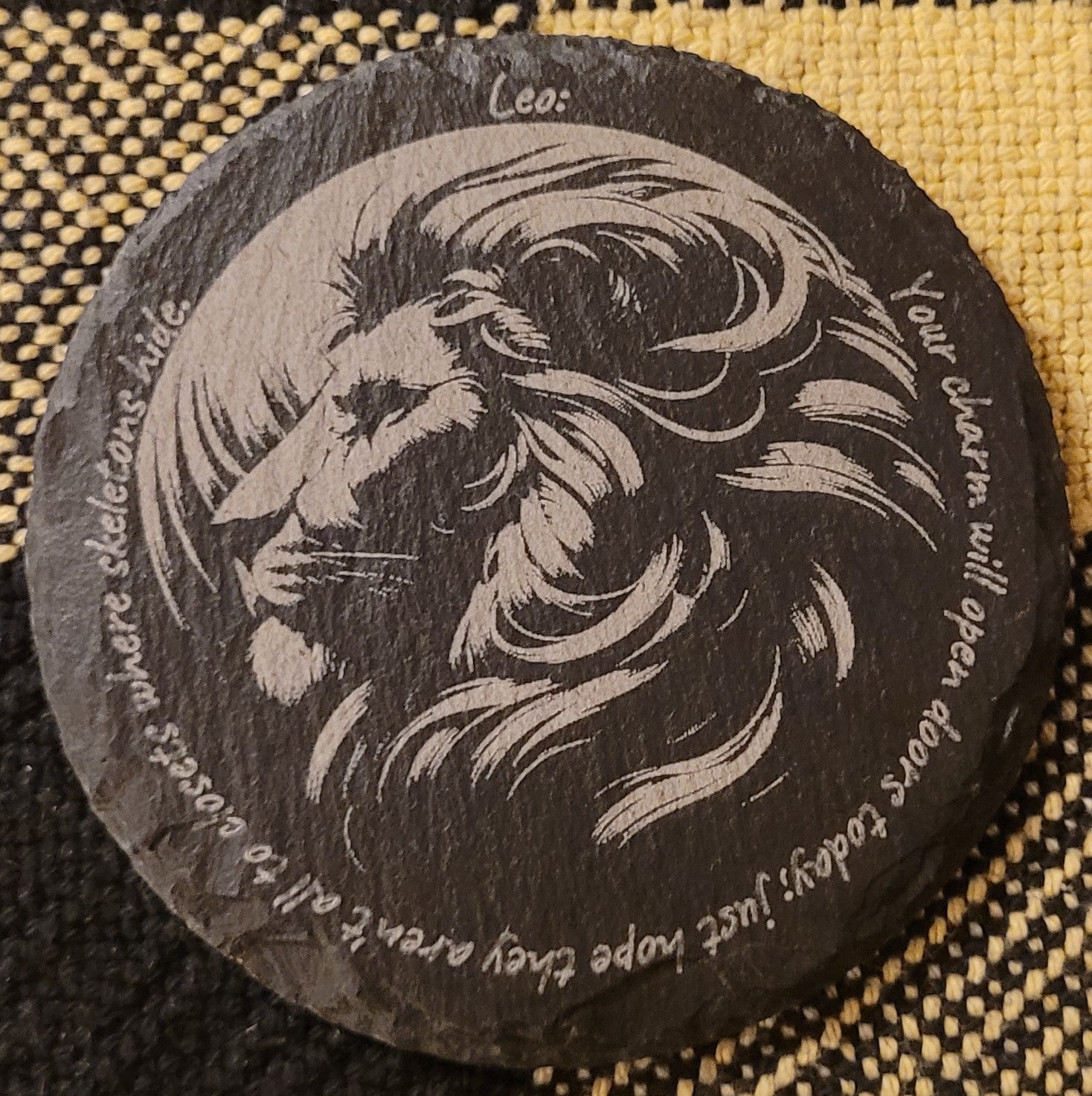 Circular stone with engraved lion design and text