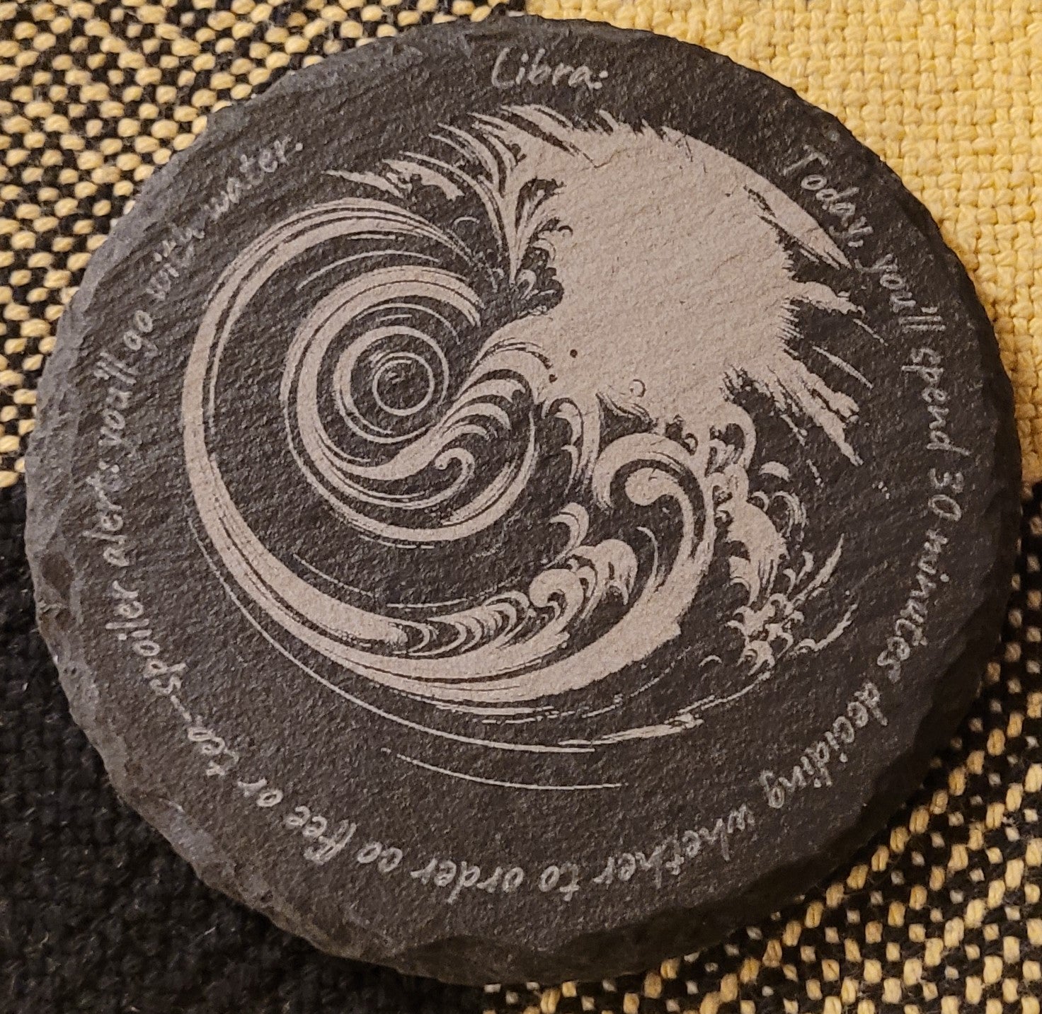 Decorative stone with wave design and text