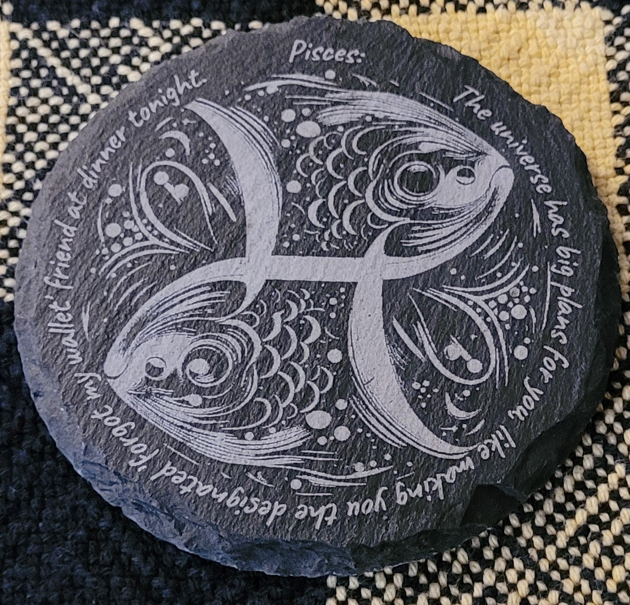 Decorative stone with Pisces zodiac symbol and text