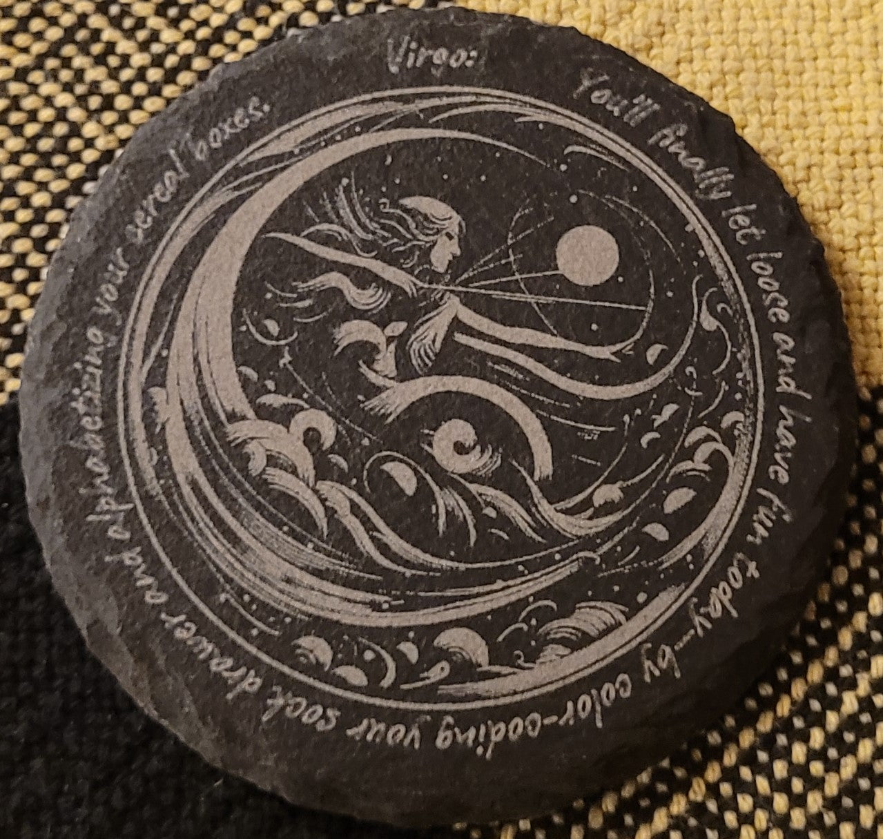 Decorative stone with a mermaid design and text
